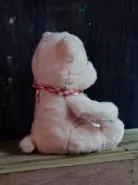 Мишка розовый в клетчатом слюнявчике 